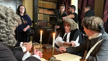 Reuben Evans directing a scene featuring actor John Rhys-Davies